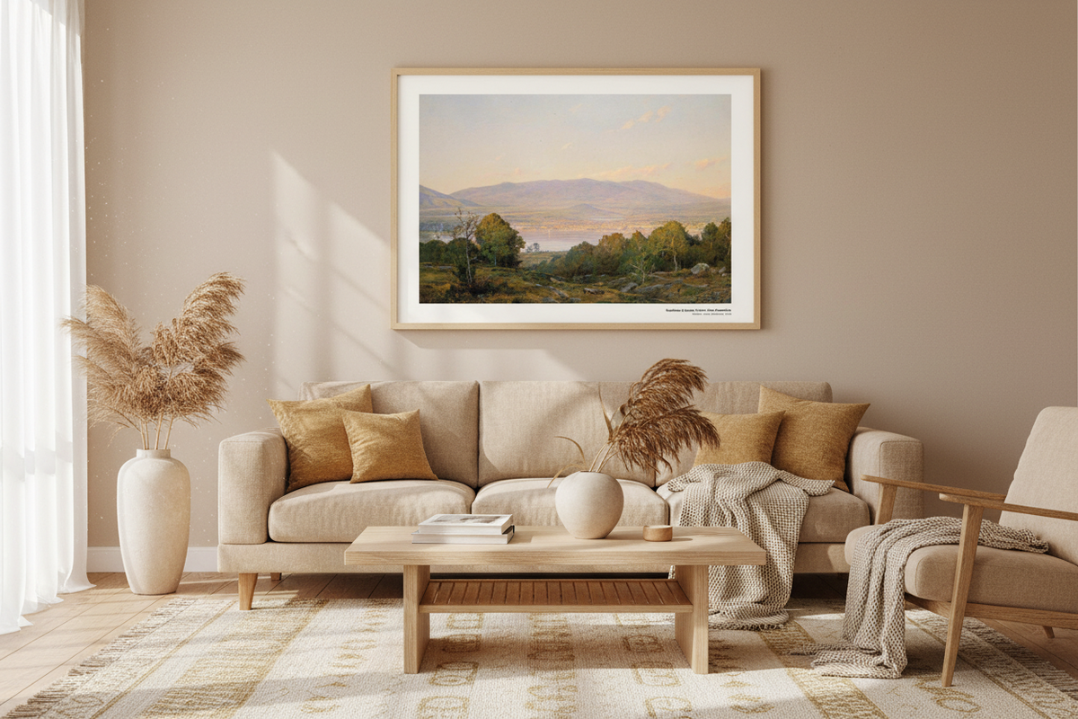 Reproduction d'un tableau de coucher de soleil dans un cadre en bois clair, accrochée au mur